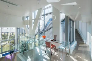 A well-designed office space featuring modern decor with glass, metal, and concrete elements.