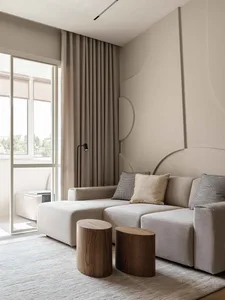 Modern minimalist living room with neutral tones and a large window