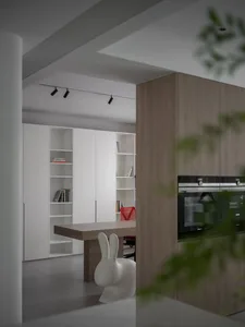 A minimalist residential kitchen with a wooden table, white chairs, and white cabinets.