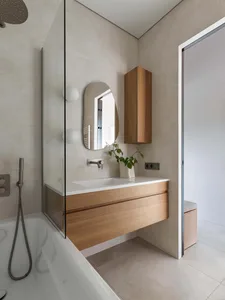 A modern bathroom featuring concrete and wooden elements.