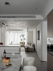 Modern residential interior with beige textiles and marble countertops.