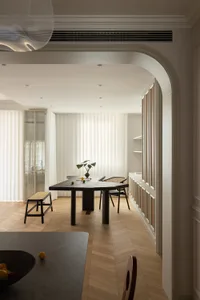 Modern minimalist dining room with wood table, glass window, and fabric curtains, featuring contemporary furniture and clean