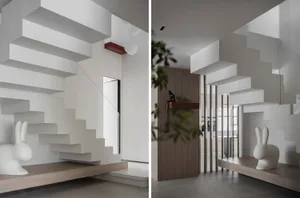 Concrete floating staircase with white rabbit sculpture