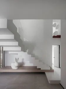 Modern minimalist interior featuring wood, concrete, and glass materials.