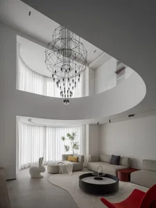 A modern living room featuring polished concrete laminate flooring and minimalist furniture.