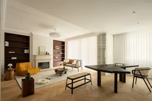 A modern living room with a contemporary design, featuring a mix of materials like wood, glass, and metal.