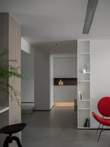 A modern minimalist interior with concrete walls and a sleek design.