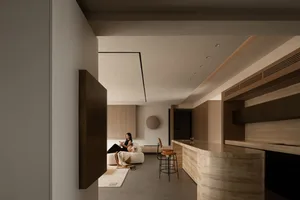 A modern living room featuring marble and wooden elements.