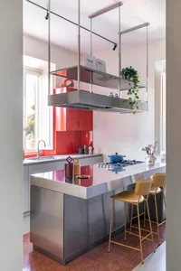 Modern minimalist kitchen with metallic accents and stainless steel appliances