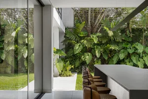 Contemporary interior design featuring concrete, wood, and glass materials.