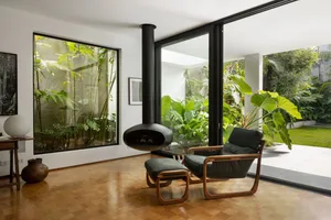 Modern industrial living room with wooden furniture and a fireplace.