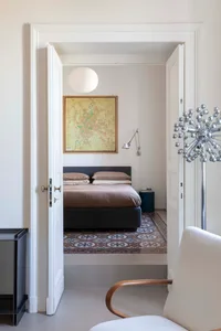 Modern bedroom featuring concrete-patterned tiles and a minimalist design.