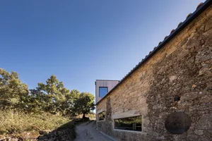 A modern building with a stone exterior and wooden accents.