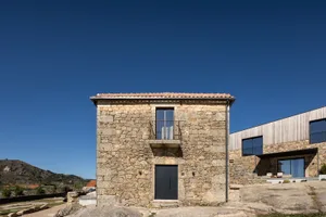 A modern holiday villa featuring a stone exterior and wooden accents.