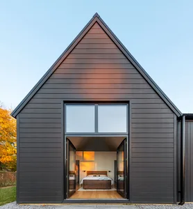 A modern residential bedroom with a large window, showcasing contemporary design elements and natural light.
