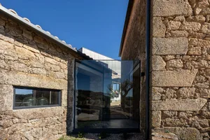 Modern building exterior made of stone with a glass window
