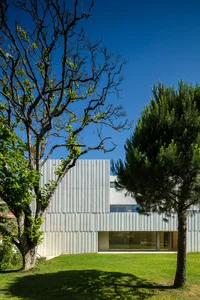A modern structure with a metallic exterior material, showcasing sleek and contemporary design