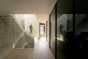Modern minimalist interior with large glass windows and clean lines.