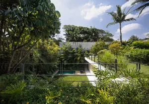 A modern residential landscape featuring concrete structures and lush greenery.