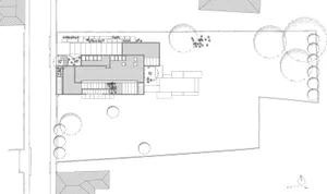 Minimalist residential space featuring transparent glass walls and exposed concrete floor.