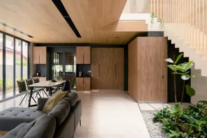 A modern living space featuring wooden furniture and a minimalist design.