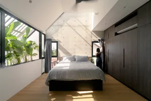 Modern minimalist bedroom featuring minimalist design with concrete and wooden elements