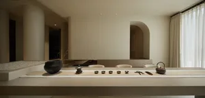 A minimalist interior design space featuring neutral-toned materials and modern furnishings.