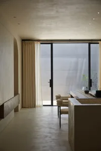 A modern, minimalist kitchen with concrete finishes and clean lines.