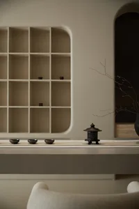 A tea room featuring ceramic tea bowls and a decorative lantern on a minimalist table.