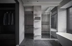Modern bathroom featuring marble and stone materials with a walk-in shower and freestanding tub.