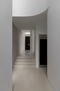 Modern hallway with concrete and brick walls and floors.