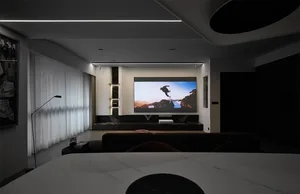 Modern living room with mixed materials, featuring a large screen displaying a person on a snowy landscape.