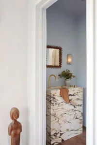 A modern bathroom with a marble countertop and a minimalist design.