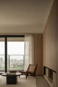 A minimalist residential space featuring wood furnishings and a glass window.