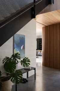 A modern residential interior featuring a combination of concrete and wood composite materials.