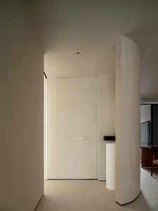 A minimalist kitchen with white walls, floor, and doors.