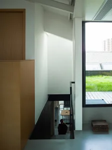 Modern interior design of a cafe featuring minimalist furniture, large windows, and wooden finishes.