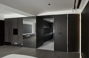 Interior design of a modern living space featuring black wood finishes and a minimalist aesthetic.
