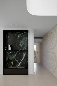 Modern interior with marble accents and concrete flooring.