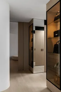 Modern minimalist closet with wooden cabinets and shelves.