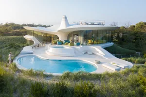 A modern house with concrete and glass features.