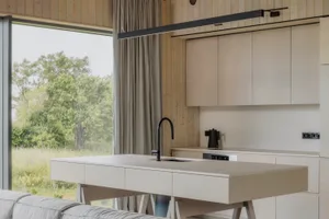 Modern residential kitchen featuring a sleek concrete countertop and minimalist design.