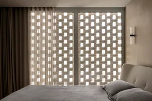 Minimalist bedroom featuring a glass partition wall