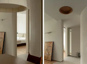 Modern interior design featuring minimalist concrete columns and lighting fixtures.