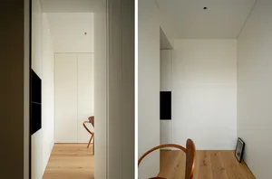 Modern minimalist white interior space with wood flooring and furniture.