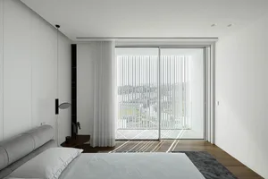 A modern bedroom featuring a white sliding glass door, minimalist furniture, and light-colored materials.