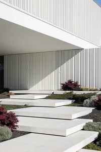 A modern exterior with concrete steps leading up to a building entrance.