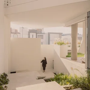 A modern residential area featuring concrete structures and greenery.
