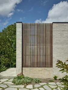 Modern exterior of a building with a brick wall and lattice window