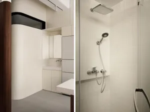 Minimalist bathroom with tiled walls and stainless steel fixtures